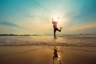 freedom asian beautiful woman  happiness jump and dance with sunset beach background